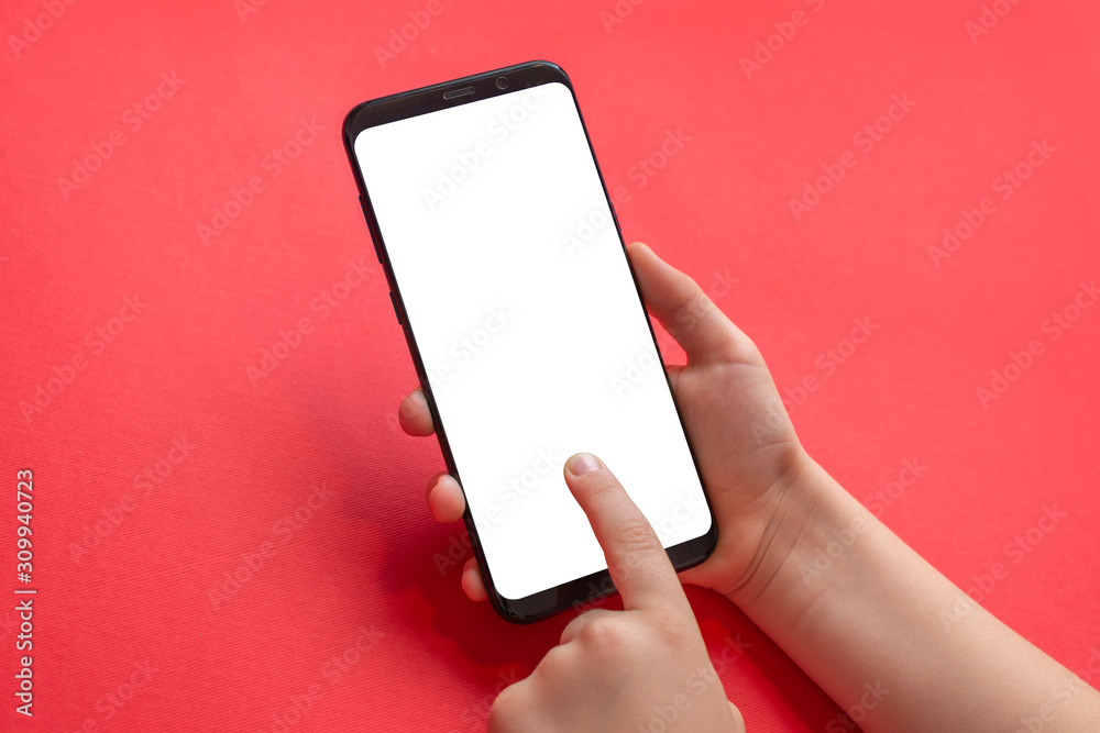 Poster phone mockup in kid hands. vertical position. isolated screen for game, app propmotion. red desk in 