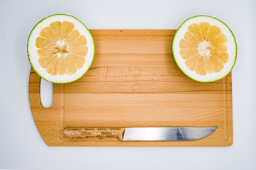 lemon and slices on wooden board