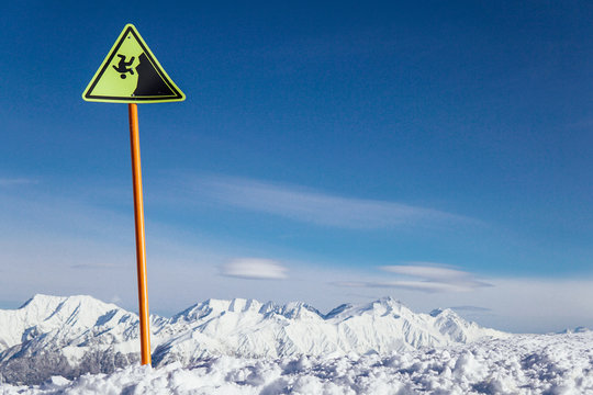 warning sign on the precipice of the ski resort snow winter
