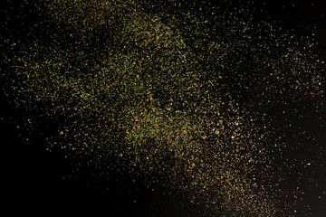 Fototapeta na wymiar Christmas Gold glitter on black background. Holiday abstract