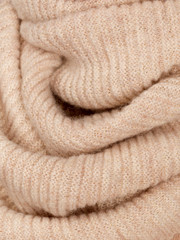 Fototapeta na wymiar Knitted fabric natural beige wool cozy texture