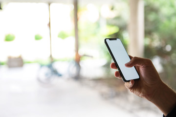 Male hand typing on mobile phone