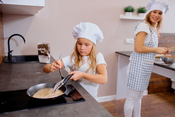 diligent and sedulous little girl cook and bake independently, make food at home without adults....