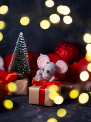 2020 new year composition . Mouse and gifts on the festive table with a garland