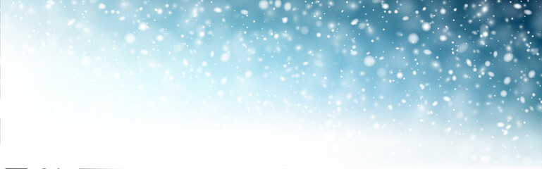 Winter blue horizontal background with white defocused snowflakes.