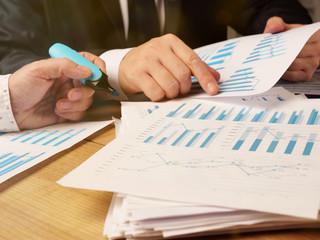 Business people are researching the reports and making trend analysis