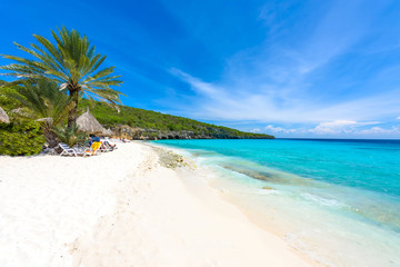 Cas Abao beach - paradise white sand Beach with blue sky and crystal clear blue water in Curacao,...