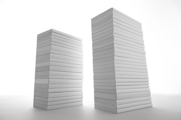 積み重ねた白い本とノートパソコン