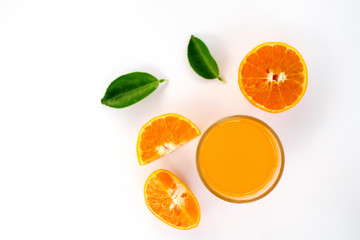 Glass of 100% Orange juice with pulp and sliced fruits isolate on white background.top view and copy space for text.