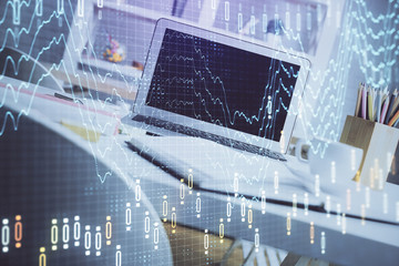 Stock market chart hologram drawn on personal computer background. Double exposure. Concept of investment.