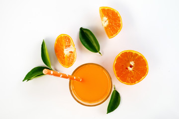 Glass of 100% Orange juice with pulp and sliced fruits isolate on white background.top view and copy space for text.