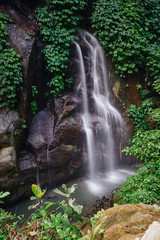  Wild forest riverside waterfall streaming from the rock at Bali       