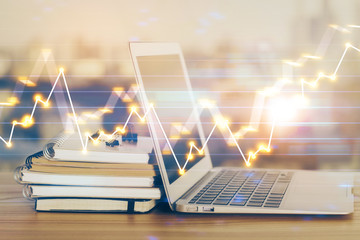 Forex market chart hologram and personal computer background. Double exposure. Concept of investment.