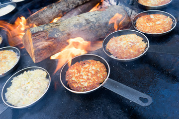 Pellets in a frying pan by the fire