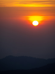 dramatic sunset over cloudy sky.