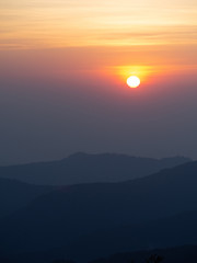 dramatic sunset over cloudy sky.
