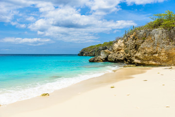 Fototapeta na wymiar Little Knip beach - paradise white sand Beach with blue sky and crystal clear blue water in Curacao, Netherlands Antilles, a Caribbean tropical Island