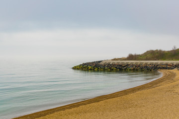 Breakwater made of concrete and granite stones revetment.  