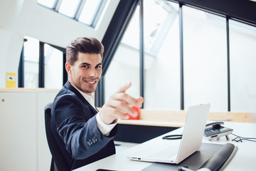 Fototapeta na wymiar Cheerful prosperous caucasian male entrepreneur satisfied with his job in office gesturing inviting to make successful career, portrait of happy businessman in suit pointing on you at work place.