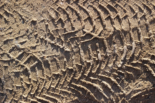 Truck tire tracks in sand, texture top down, close up