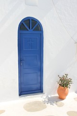 blue door in stone wall