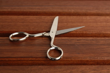 sewing scissors on wooden background