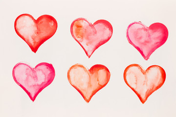Watercolor painted pink heart, on the white watercolor paper.