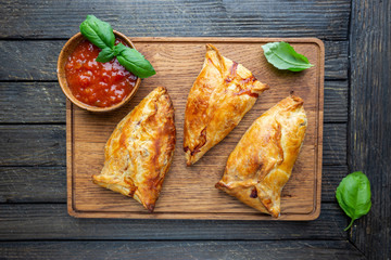 Asian food Samsa or samosas with chicken fillet on cutting board. Top view