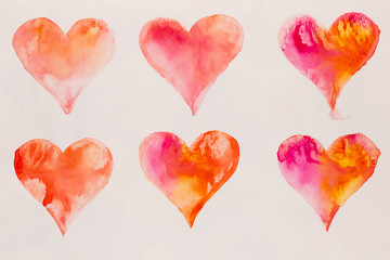 Watercolor painted pink heart, on the white watercolor paper.