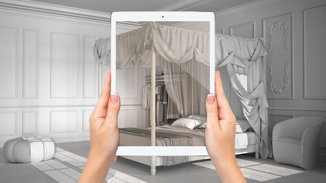 Hands holding tablet showing classic bedroom with canopy bed, total blank project background, augmented reality concept, application to simulate furniture, interior design products