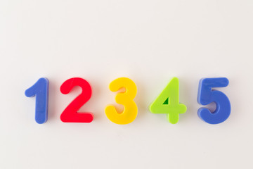 Colorful plastic numbers from one to five isolated on white background