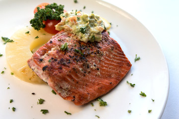 Caramelized Pineapple salmon fillet with celery served on a white plate
