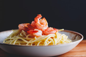 Fried shrimps on the pasta. The concept of dinner or lunch with seafood.