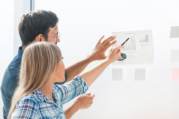 businessman standing near the Board with a financial schedule.