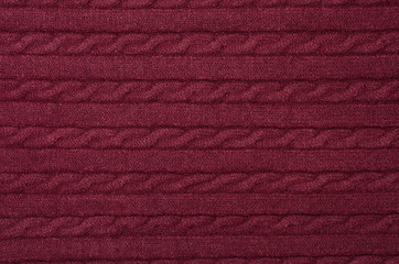 texture of wine woolen knitted sweater near background