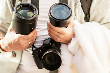 camera and lenses in the hands of a young photographer