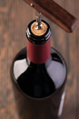 Corkscrew and bottle of wine