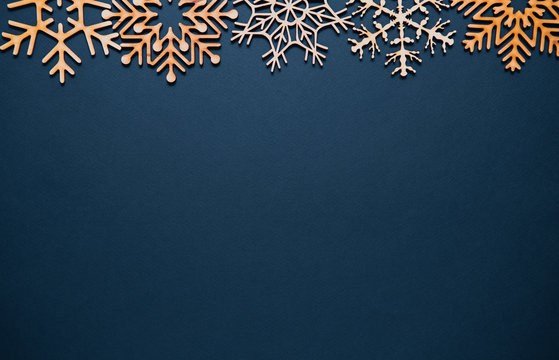 Flat lay Christmas background with hand made wooden snowlake toys