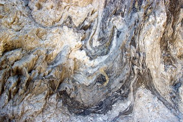 Dry salt at the surface of a rocky cliff at a beach by the sea at summer in Greece. Abstract textured background