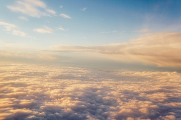 Sunset above the clouds landscape from an airplane journey