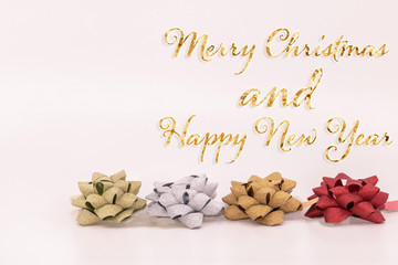 Noeuds en bolduc or argent et rouge pour Noël avec le texte scintillant doré en anglais Merry...