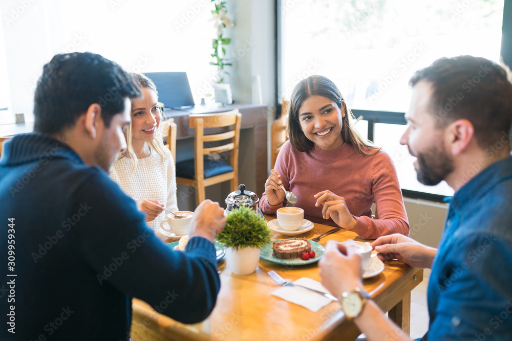 Wall mural friends spending leisure time in cafe