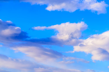Dramatic puffy clouds isolated against blue skies