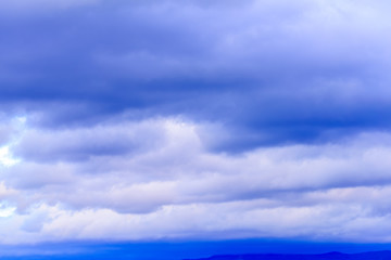 Dramatic puffy clouds isolated against blue skies