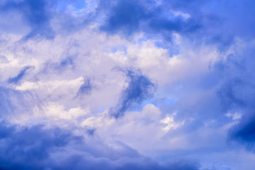 Dramatic puffy clouds isolated against blue skies
