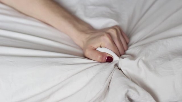 young woman squeezing  white sheets with a hand