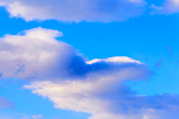 Dramatic puffy clouds isolated against blue skies