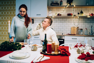 Girlfriend serving pizza to boyfriend on Christmas