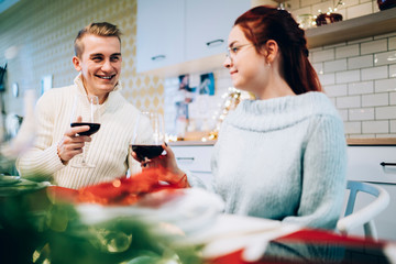 Happy couple drinking wine on Christmas eve