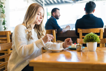 Female Enjoying Coffee At Cafe